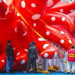 The Yayoi Kusama balloon, which is a red sun with white polka dots, is being inflated